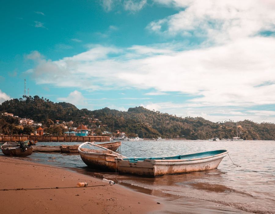 Fishing boats resting on the sand of a beach in Samaná