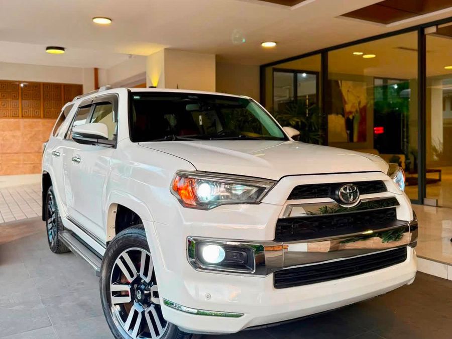 Toyota 4Runner blanca de Mobility Rent a Car, estacionada bajo un portal moderno